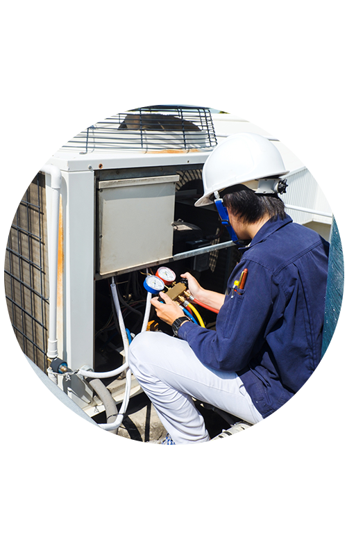 Technician Inspecting HVAC System on Rooftop with Tools in Hand