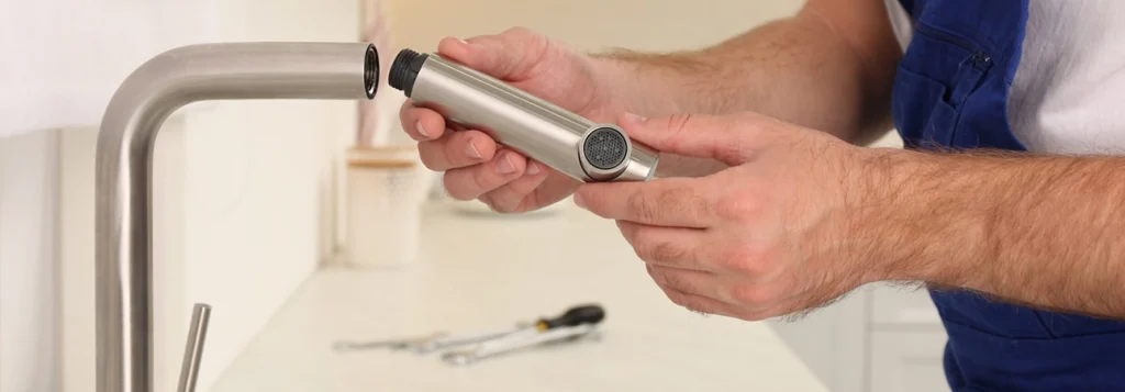 Plumber Repairing Modern Kitchen Faucet for Plumbing Repair Services