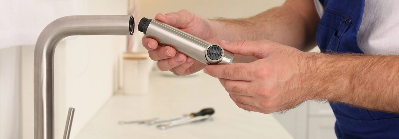 Plumber Repairing Modern Kitchen Faucet for Plumbing Repair Services