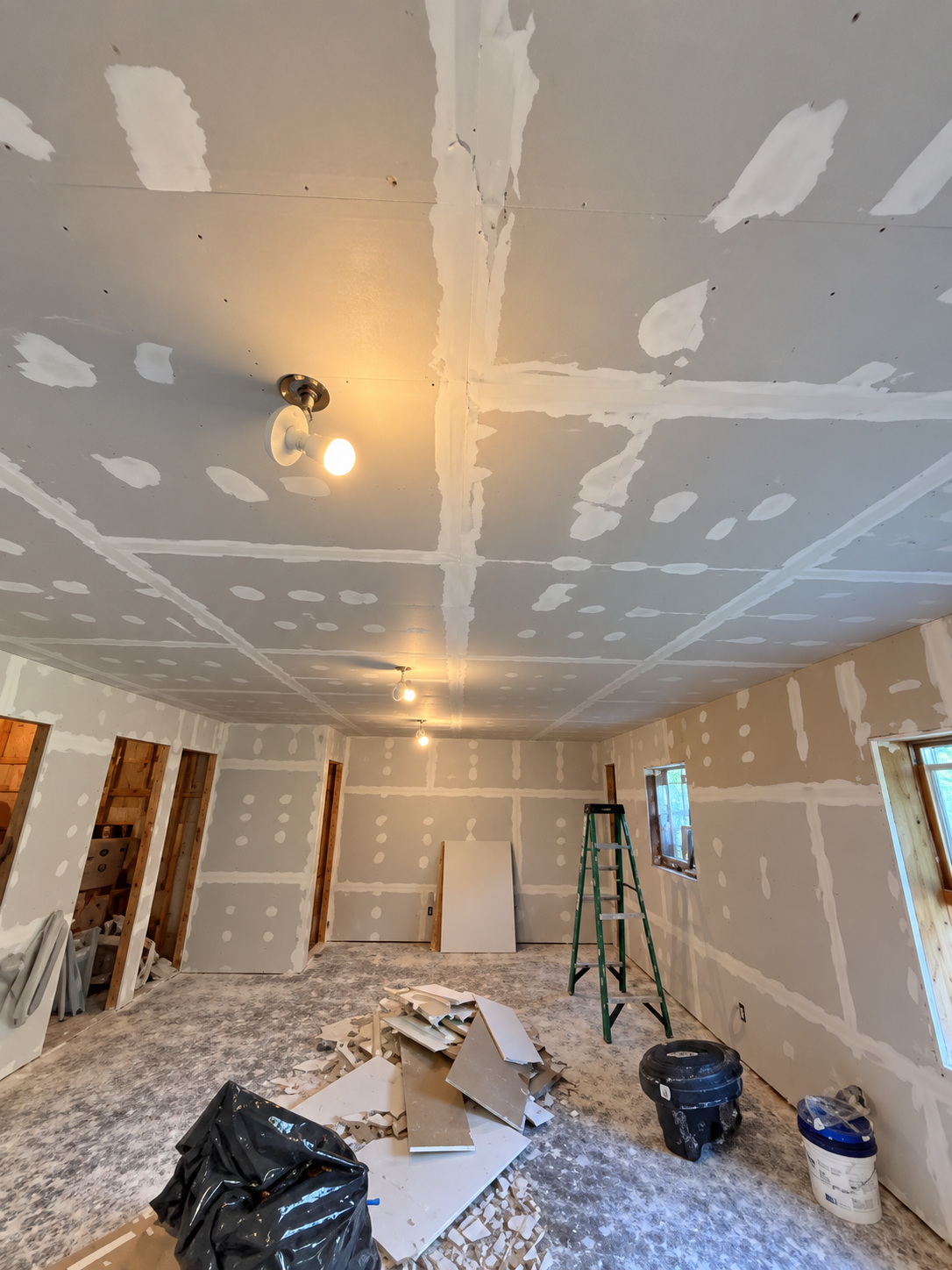 Room Under Renovation With Exposed Drywall and Construction Materials